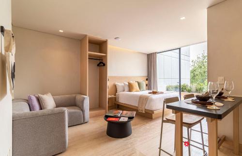 a hotel room with a bed and a couch at Casa Calderón by Kukun in Mexico City