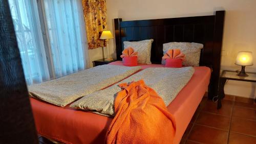 a bedroom with two beds with orange and pink shoes at Apartamentos-Monasterio-de-San-Antonio-Guenstiges-Apartment-zur-Strasse in Icod de los Vinos