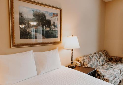 a hotel room with a bed and a couch at Carriage House Country Club in Pocono Manor