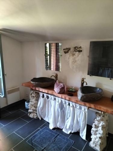 une salle de bain avec deux lavabos sur un comptoir dans l'établissement Le SPA d'Adélaïde son jacuzzi privé, à Andillac