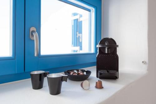 a kitchen counter with a bowl of food and cups at Blue Paros House Paroikia Center close to port in Kampos Paros