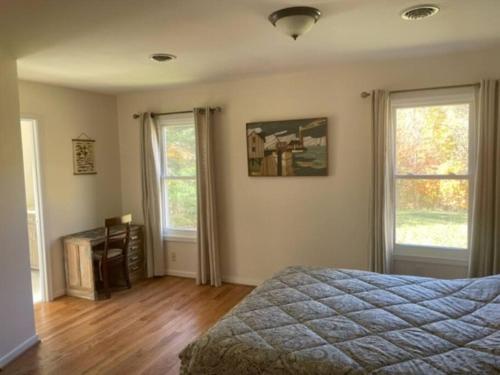 a bedroom with a bed and two windows at Sperryville 3 BR house next to Blue Ridge Mts. in Sperryville