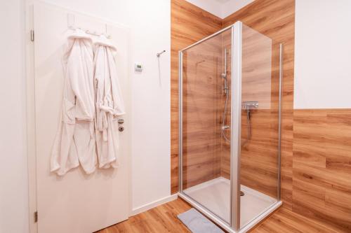 a bathroom with a shower with a glass door at App 8u Heimatliebe in Dranske