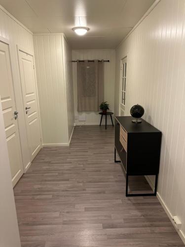 an empty hallway with a dresser in a room at Vardø accommodation - white house in Vardø