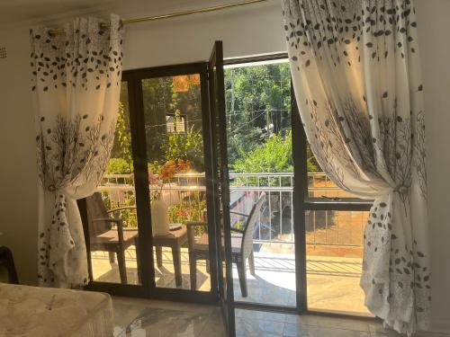 a room with a sliding glass door to a patio at Casa 57 in Pietermaritzburg