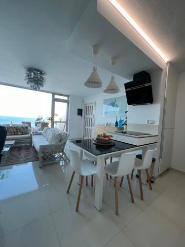 cocina y sala de estar con mesa y sillas en Playa del Hombre Deluxe Luxury Apartments en Playa del Hombre