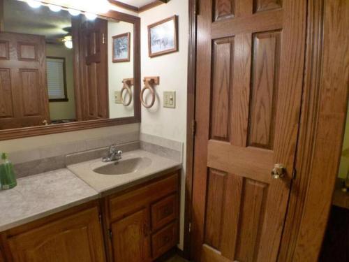a bathroom with a sink and a mirror at Hocking Hills Cottage with beautiful pond in Logan