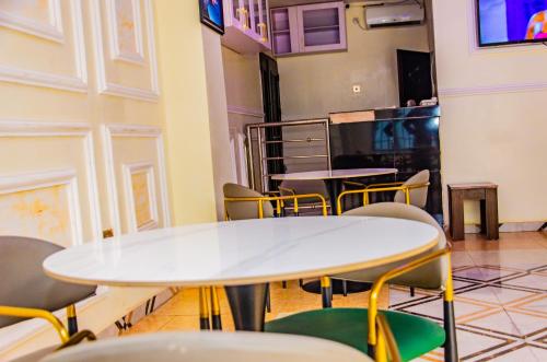 stół i krzesła w pokoju z telewizorem w obiekcie E45 Hotels and Suites w Owerri