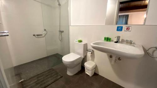 a white bathroom with a toilet and a sink at Spacious Country House in Arteara near Maspalomas in Artedara