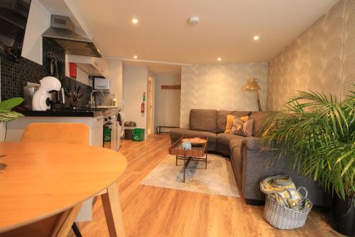 a living room with a couch and a table at Streamside Apartments in Yeovil