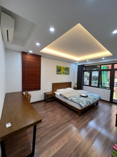 a bedroom with a bed and a wooden floor at 54 homestay văn miếu in Hanoi