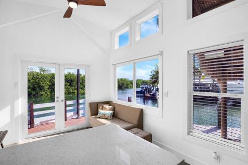 une salle à manger avec des fenêtres et une vue sur l'eau dans l'établissement Tiny Home on Waterfront, Bay Views, Deck, Pool, à Jewfish