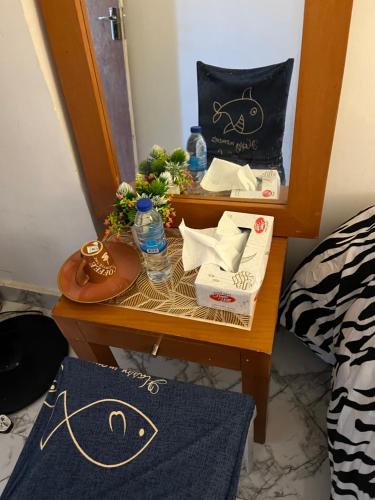 a nightstand with a table in a room at MY STAY in Abu Dhabi