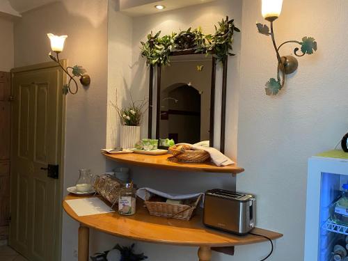 a bathroom with a counter with a mirror and a sink at Hotel Weinstube am Markt in Gerolzhofen