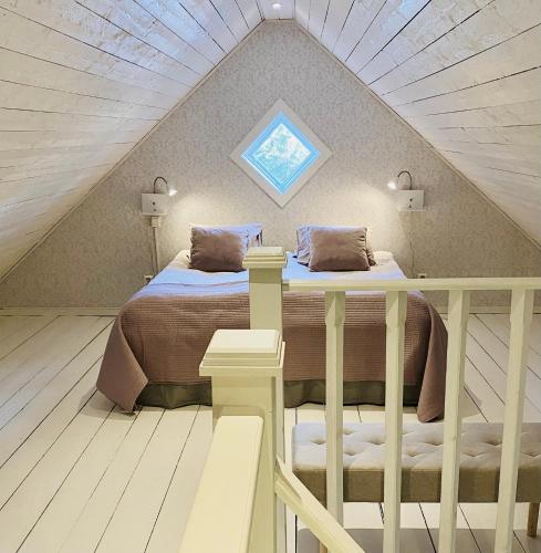 a attic bedroom with a bed and a skylight at Slamrekullen - Ullared in Ullared
