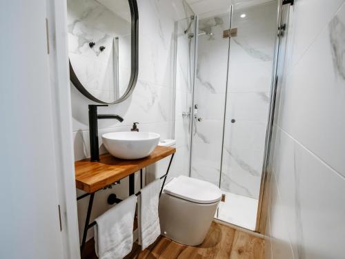 a bathroom with a sink and a shower at Sweet Lloret Suites in Lloret de Mar