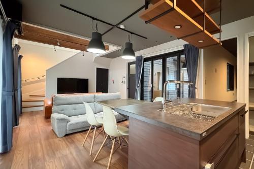 a kitchen and living room with a couch at Casa Stay Kokura 1 - Vacation STAY 18791v in Kitakyushu