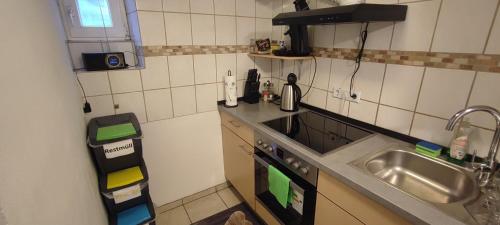 a small kitchen with a sink and a stove at Studio Ferienwohnung Untergeschoss in Ostrach