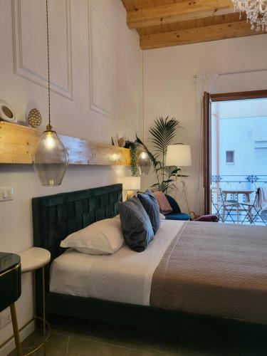 a bedroom with a bed with pillows on it at Atrium in Castellammare del Golfo