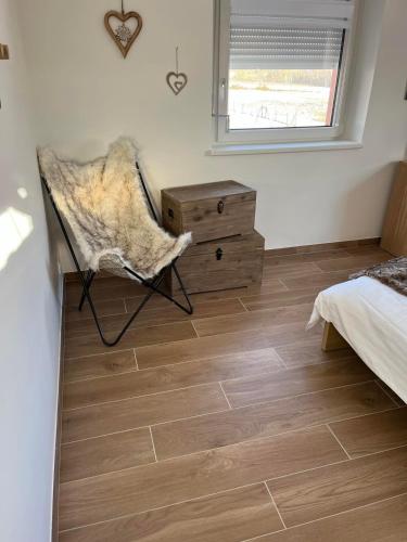 a bedroom with a bed and a dresser and a chair at La Perle d'Alsace in Bernardswiller