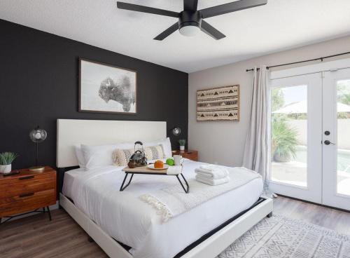 a bedroom with a white bed with a table on it at Scottsdale - 6839 E Kelton Lane in Scottsdale