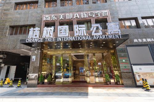 an entrance to an office tree international apartment building at Orange Tree International Hotel Zhujiang New Town Huacheng Sqaure Branch - Free Shuttle Bus to Canton Fair Complex During Canton Fair Period in Guangzhou