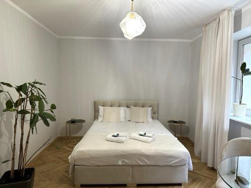 een slaapkamer met een bed met twee handdoeken erop bij Art Deco Apartment in Warschau