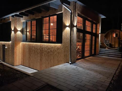 a front door of a building at night at Ferienwohnung Loft Schwielowsee mit Sauna in Schwielowsee