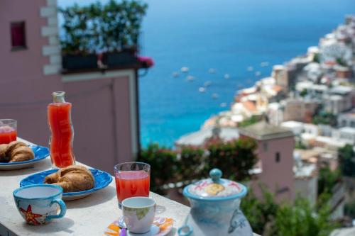 a table with plates of food and a view of a city at Casa Donna Cunce in Positano