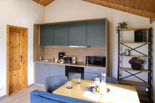 a kitchen with a table and chairs and a counter at Natur- und Aktivresort Senftenberg in Schipkau