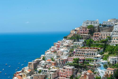 a group of houses on a hill next to the ocean at Casa Donna Cunce in Positano