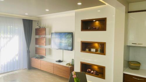 a living room with a tv on a wall at Gabrijel Apartments Makarska 2 in Makarska
