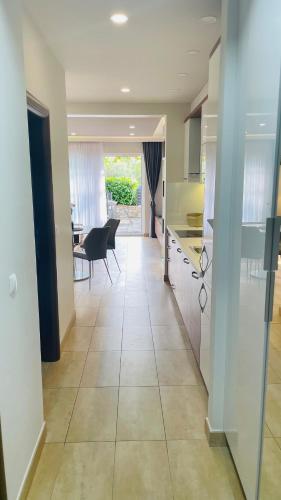 a kitchen and dining room with a table and chairs at Gabrijel Apartments Makarska 2 in Makarska
