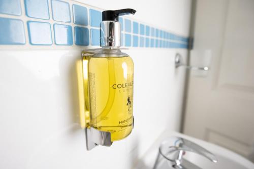 a bottle of soap hanging on a bathroom wall at Number 7 Guest House in Whitby
