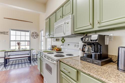 a kitchen with green cabinets and a white stove top oven at Game Room and Patio Family Afton Retreat! in Afton