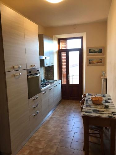 a kitchen with a table and a counter top at Casa La Quercia in Chiusi della Verna