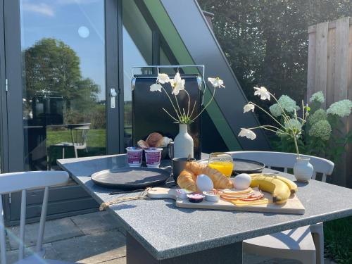 a table with a tray of food on a patio at Hotelhuisjes Medemblik in Wieringerwerf