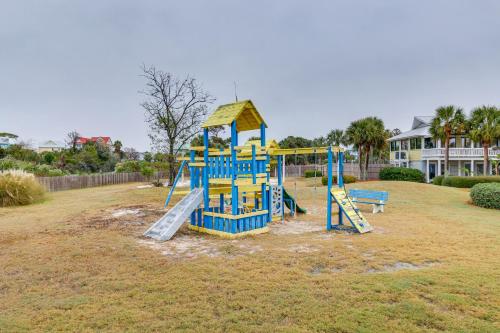 a playground in a yard with a slide and a bench at Pool Access and Views at Saint Helena Island Condo! in Oceanmarsh Subdivision