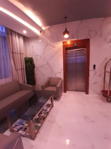 a living room with a couch and a door at HOTEL MDOPE MBEYA in Mbeya