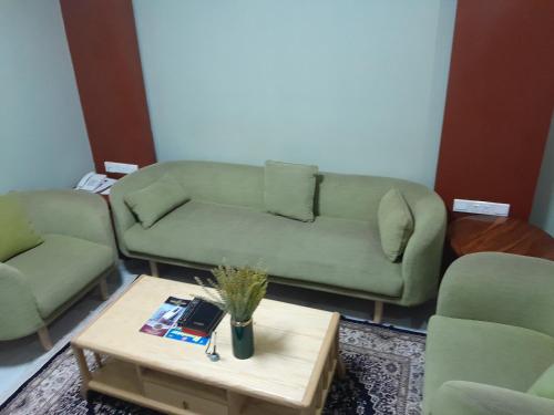 a living room with a couch and a coffee table at HOTEL MDOPE MBEYA in Mbeya