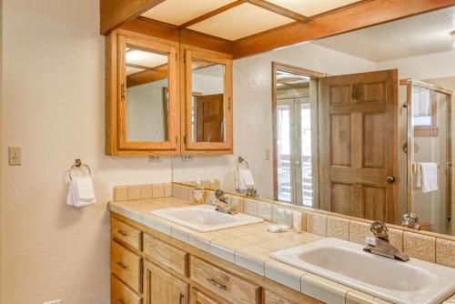 a bathroom with two sinks and a large mirror at Skyland Retreat - Max nighttime occupancy of 8 in Zephyr Cove