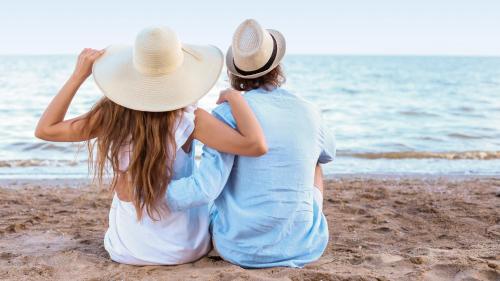 two women sitting on the beach looking at the ocean at Apartament Doris 1 z pięknym widokiem in Pobierowo