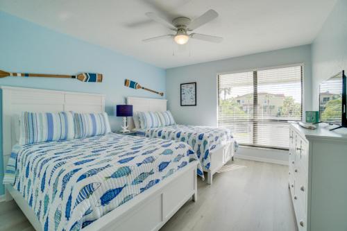 a bedroom with two beds and a ceiling fan at Bay Views and a Short Walk to Beach in Bradenton Beach