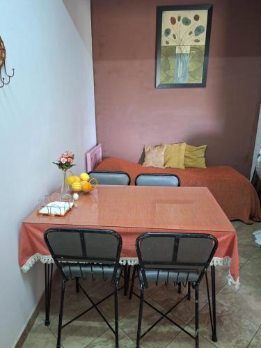 a room with a table with chairs and a bed at Elenas Home in Limassol