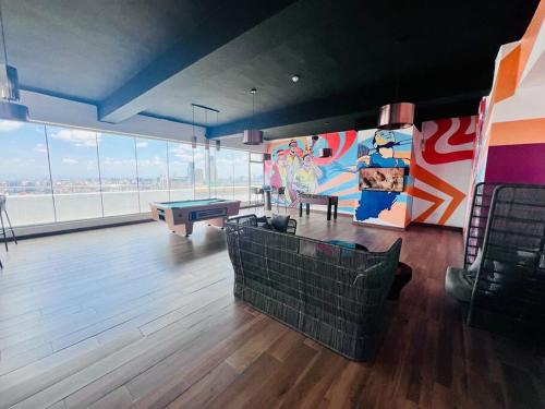 a room with a ping pong table and a mural at Skynest - 15th Floor in Nairobi