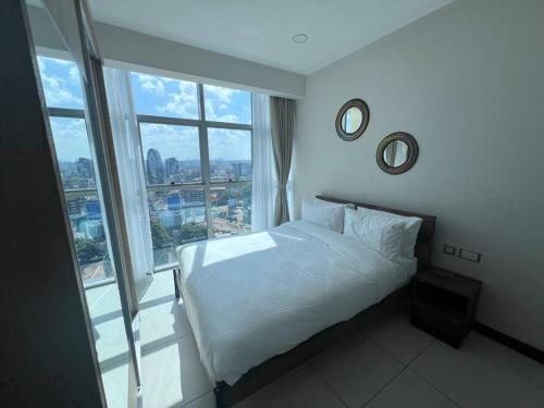 a bedroom with a bed and a large window at Skynest - 15th Floor in Nairobi