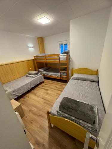 a room with three beds in it at MASIA LA MOLINERA in Xerta