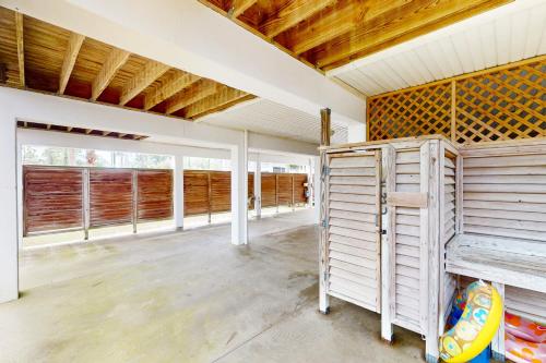 an empty room with wooden ceilings and windows at Pleasant Tides in St. George Island