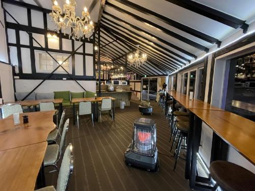 a restaurant with tables and chairs and a bird cage at Hakuba Sun Valley Hotel Annex - Vacation STAY 40560v in Hakuba