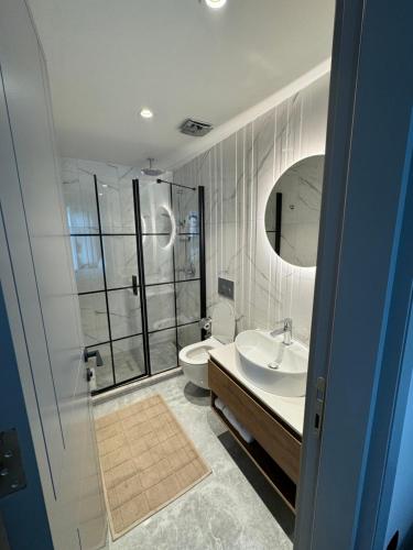 a bathroom with a shower and a toilet and a sink at Bella Mare Residence Luxury Apartment in Famagusta